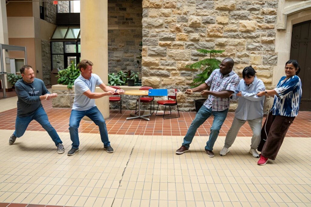Chemists demonstrate the strength of one of their new adhesives in a tug-of-war between faculty members and students – the rope broke before the adhesive gave out