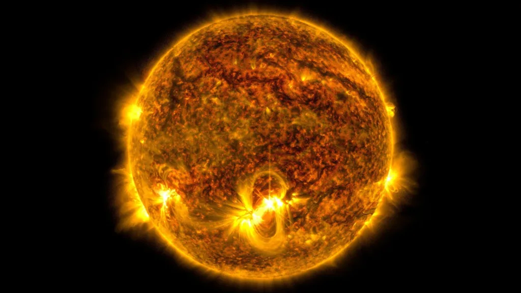 A grid of small square images arranged in rows and columns, showcasing faint astronomical objects captured against the darkness of space. Each square focuses on a central brown dwarf, ranging in color from bright white and orange to deep red.